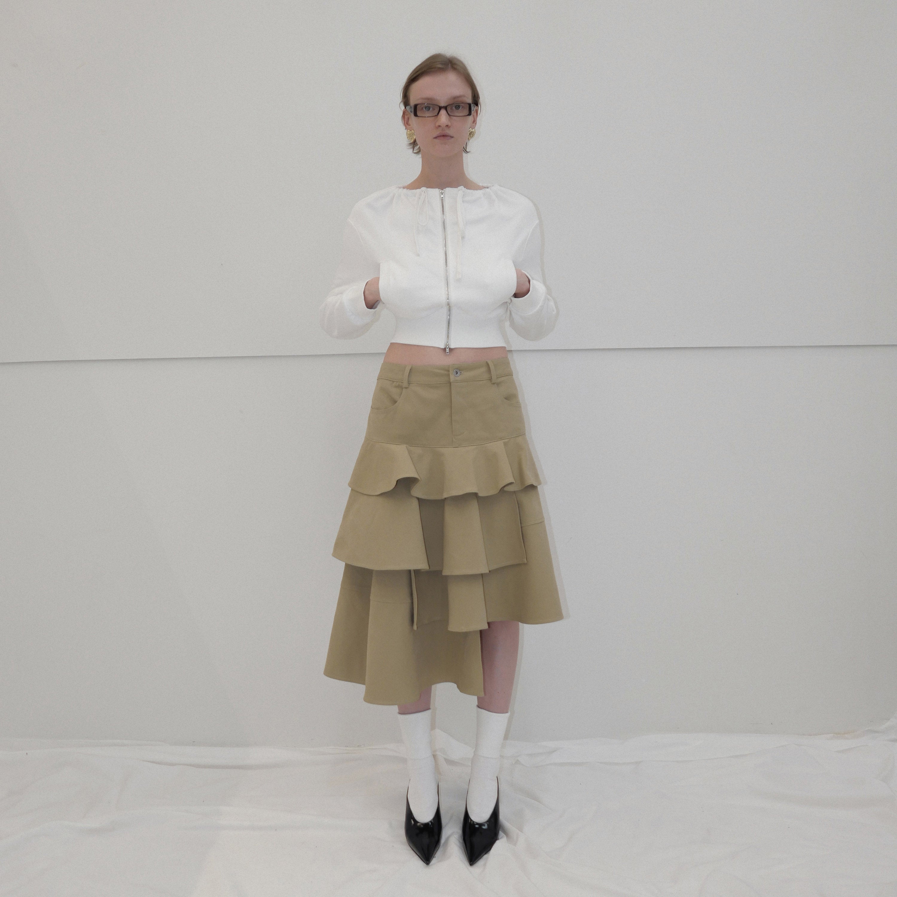 Asymmetrical layered outlet skirt